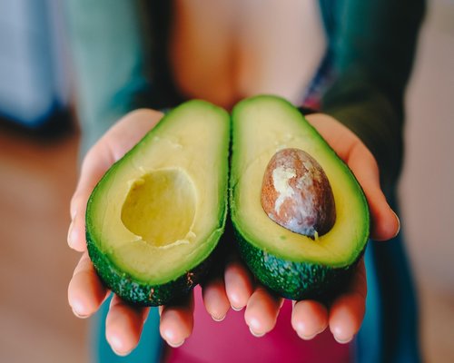 Halved avocado showing the seed inside